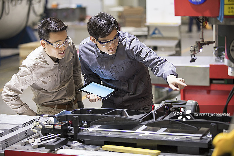 自信的工程师在工厂讨论工作图片素材