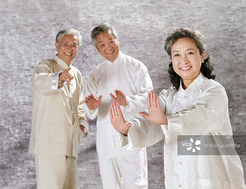 three oriental senior adults doing Taijiquan图片素材