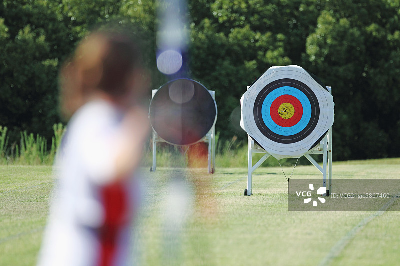 瞄准目标的年轻女弓箭手图片素材