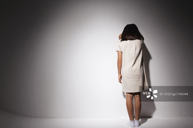 靠墙哭泣的白裙女孩图片素材