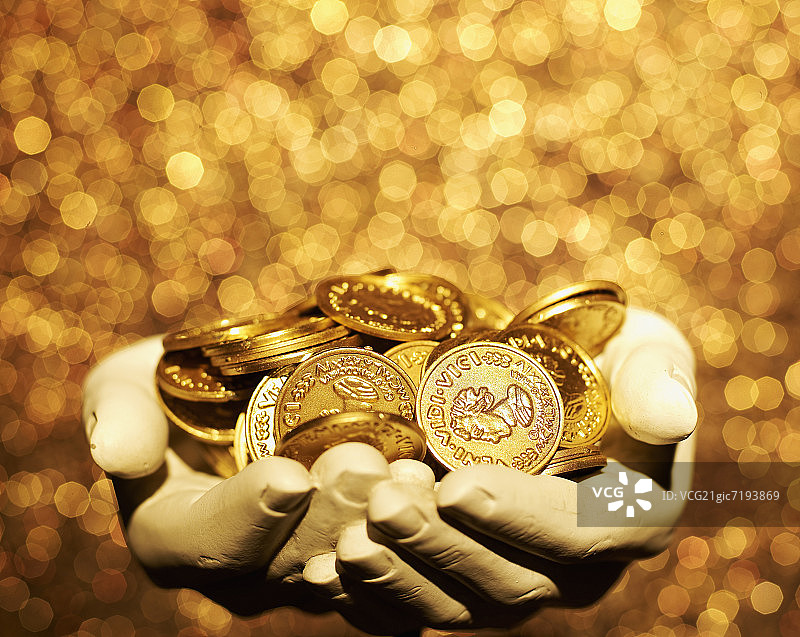 手持金币雕塑图片素材