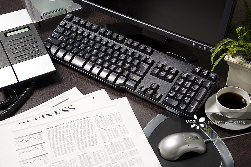 咖啡、电话和报纸旁的台式电脑图片素材