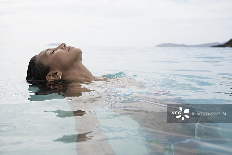 年轻女子在水中游泳图片素材