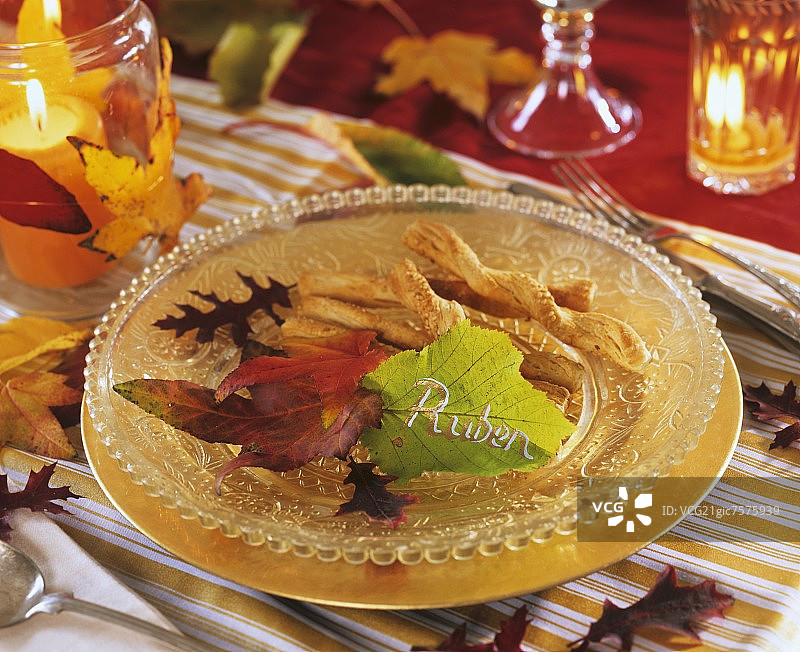 玻璃盘里的美味饼干与秋叶图片素材