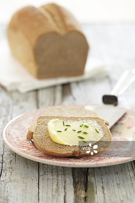 棕色面包涂有黄油和细香葱图片素材