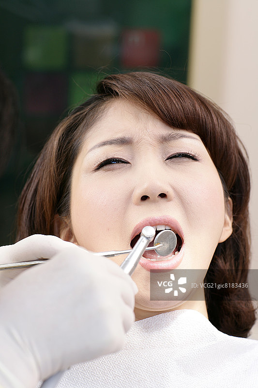 牙医向患者展示牙齿模型，微笑图片素材