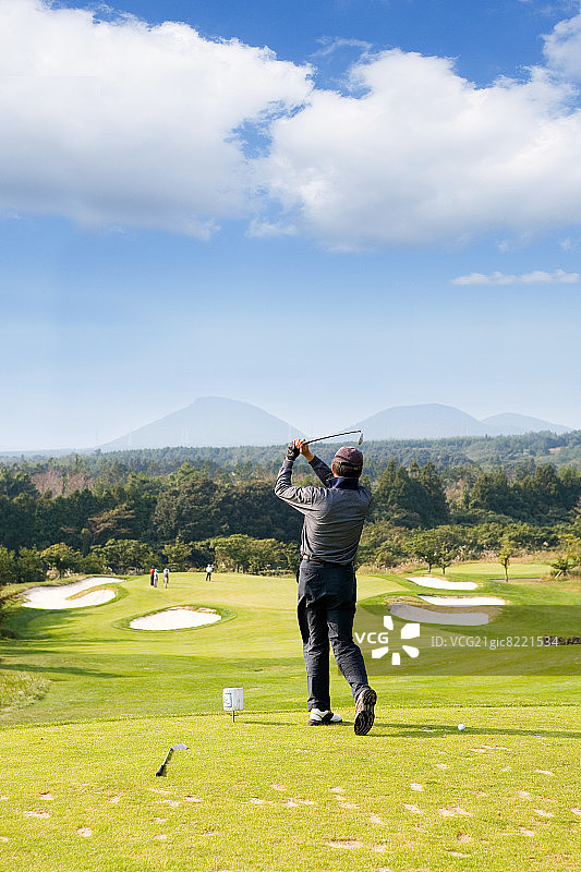 高尔夫球手在球场上开球图片素材
