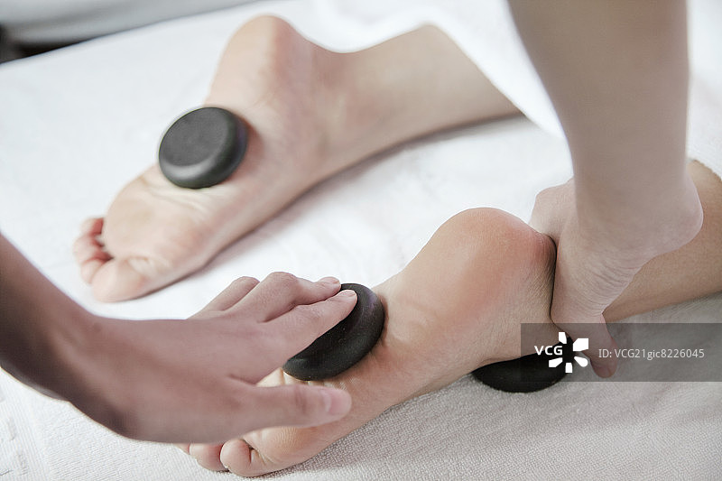接受热石足部按摩的女人图片素材