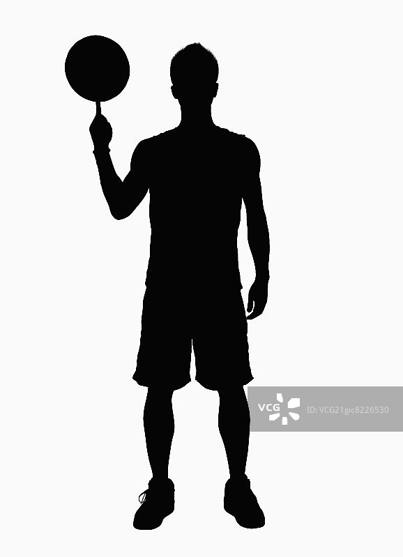 篮球运动员手指旋转篮球的剪影图片素材