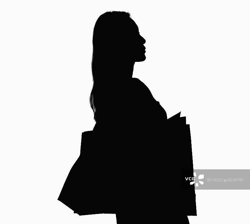 提着购物袋的女子剪影图片素材