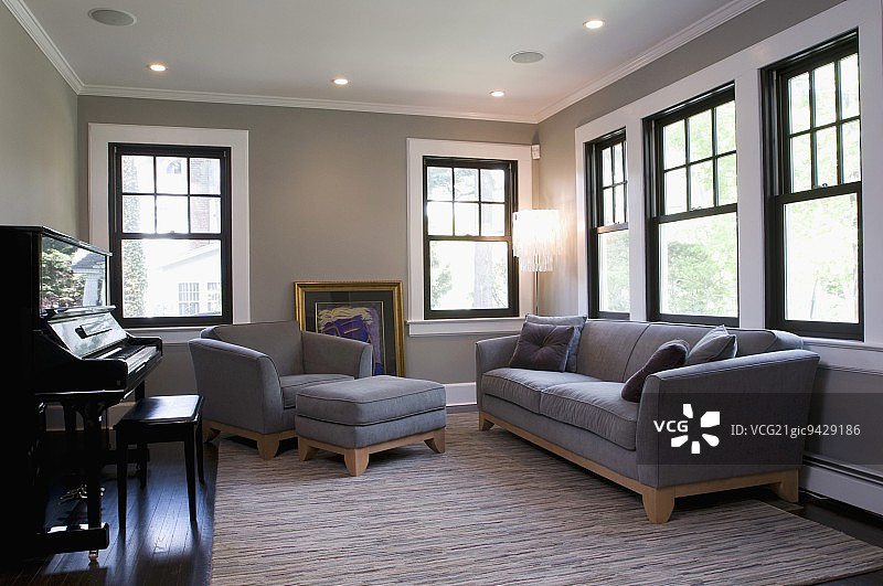音乐室内的灰色沙发、扶手椅和脚凳图片素材