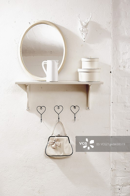 带手提包、置物架、镜子和鹿角的衣架图片素材