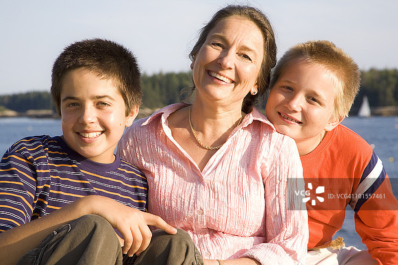 母亲和儿子在海岸线旁图片素材