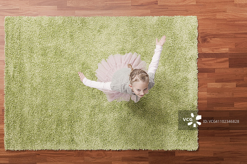 德国科隆：在地毯上玩耍的女孩(6-7)，抬头，仰视图片素材