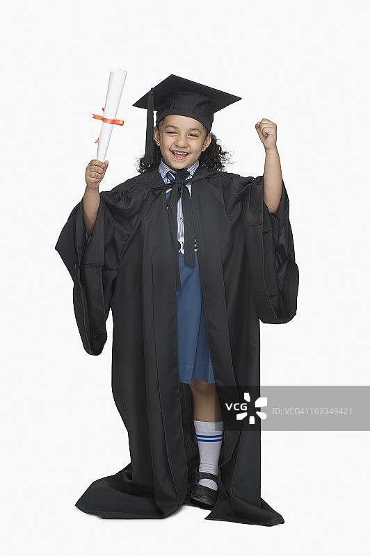 身穿毕业礼服，手持文凭的女孩肖像图片素材