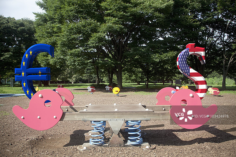 跷跷板上平衡的货币符号图片素材