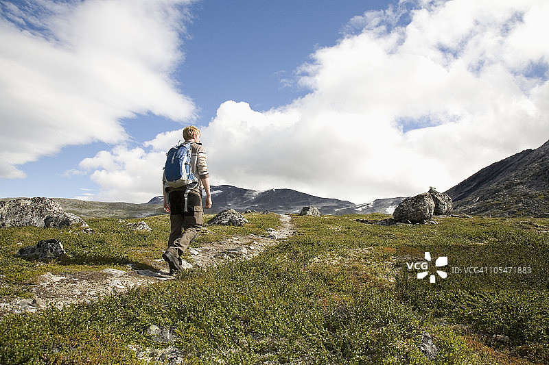 男子在山间小道上徒步图片素材