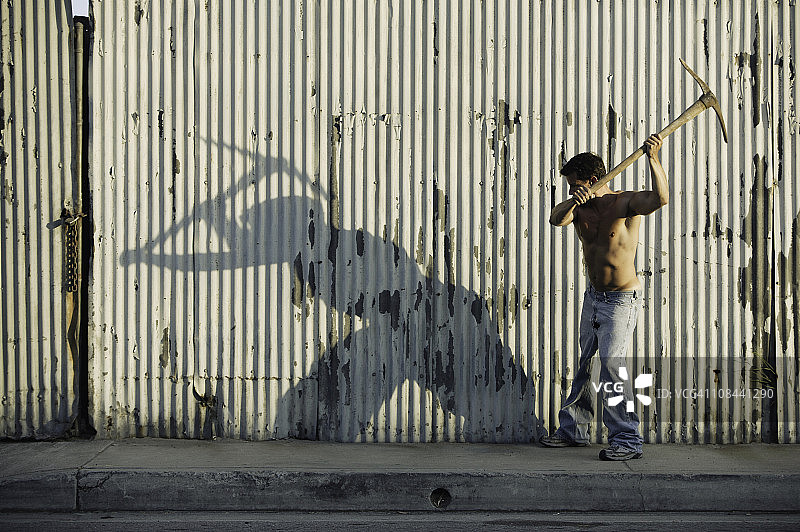 美国加利福尼亚州洛杉矶，赤膊男子挥镐图片素材