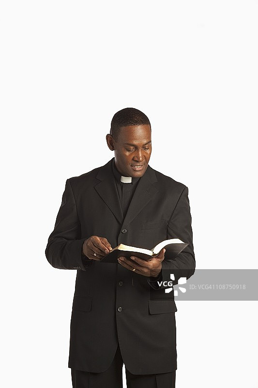 男人戴着牧师领，正在读圣经图片素材