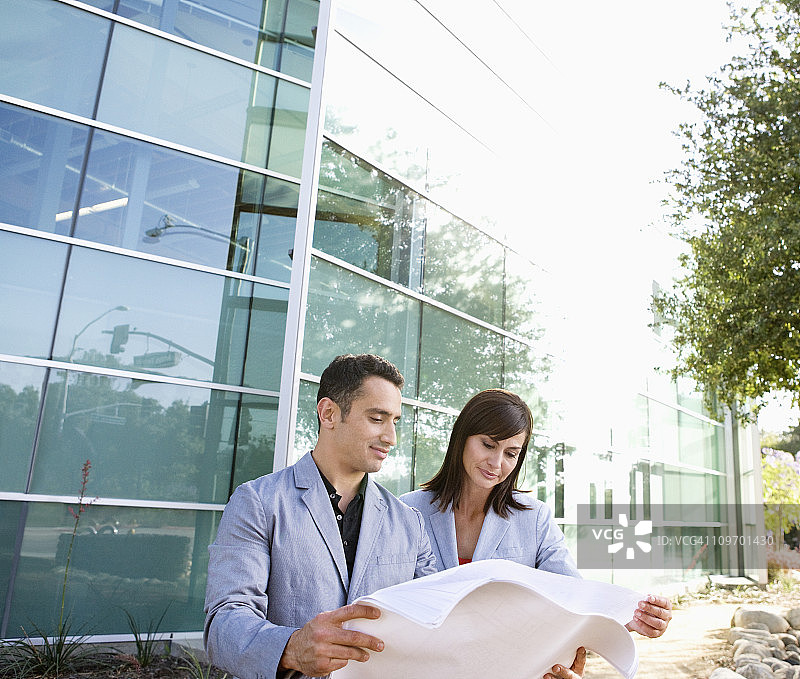 两位商务人士在户外看文件图片素材