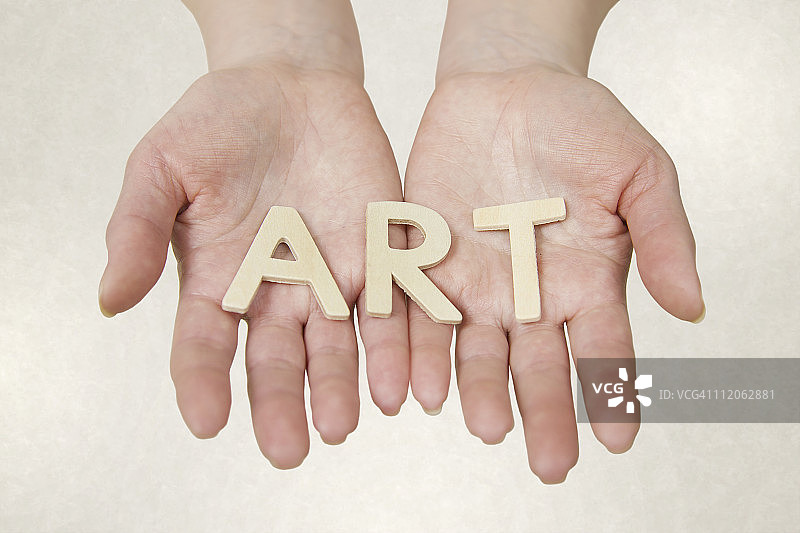 双手拿着拼写单词的字母图片素材