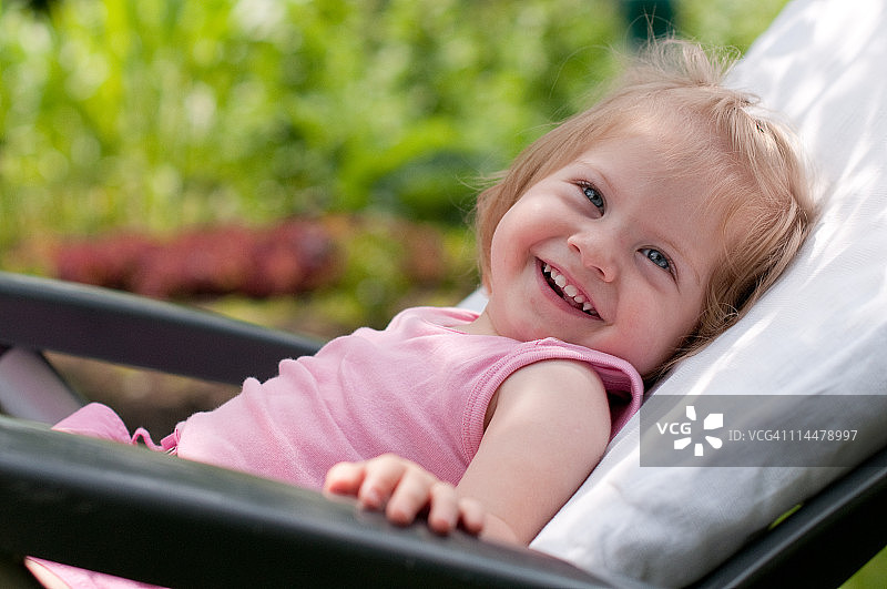 坐在草坪椅上的幼儿女孩图片素材