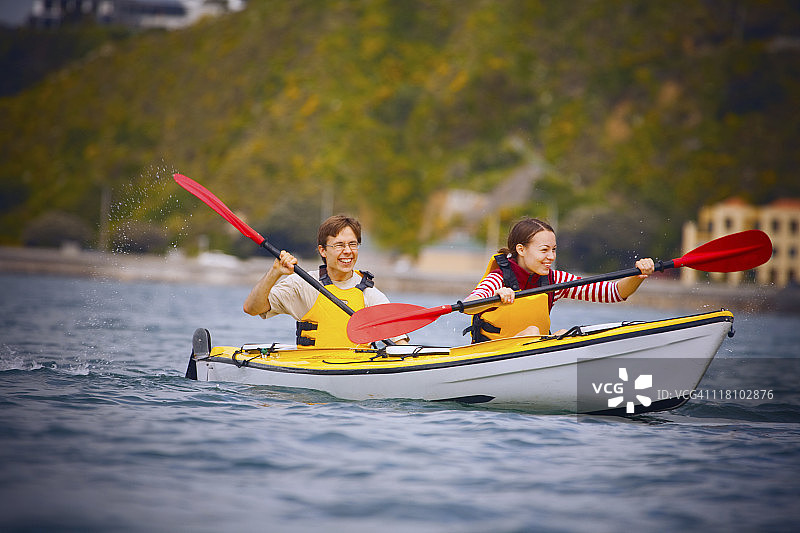 年轻情侣海上皮划艇运动图片素材