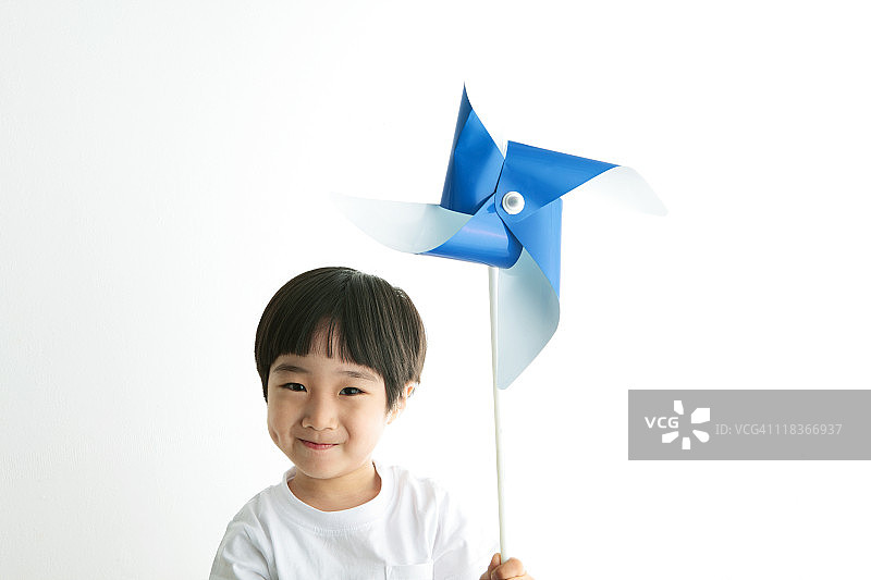 小男孩拿着纸风车微笑图片素材