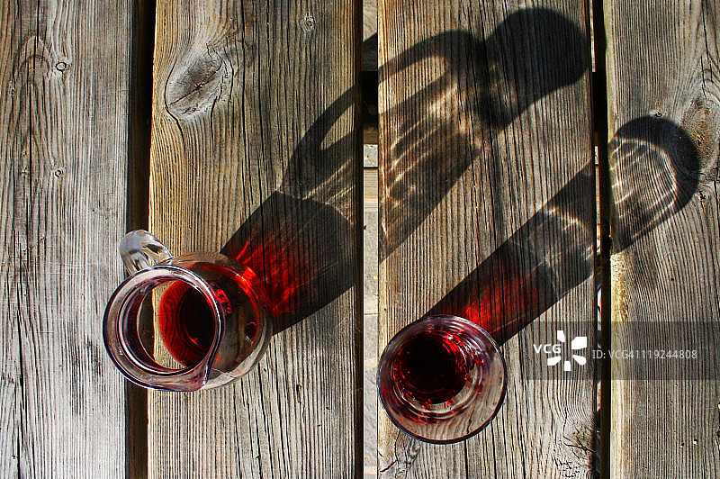 旧木桌上的红酒醒酒器和酒杯图片素材