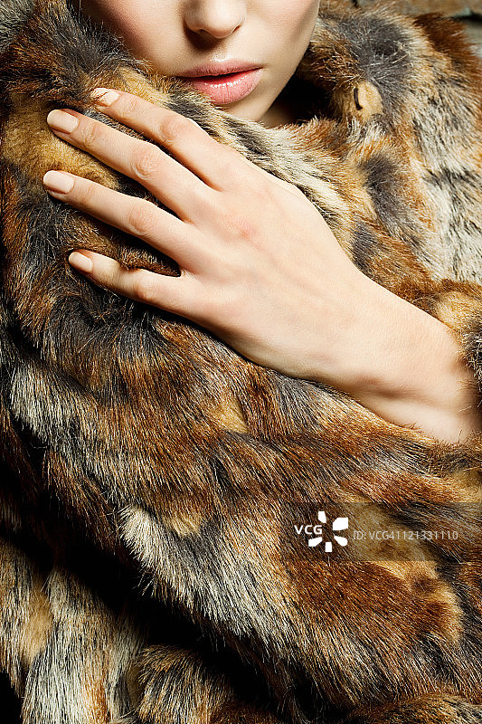 身穿皮草大衣的年轻女人图片素材