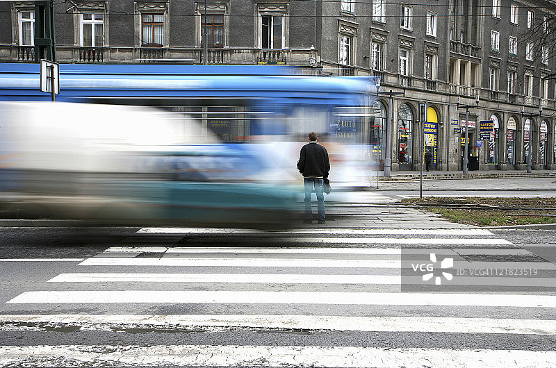 男子在波兰克拉科夫的诺瓦胡塔过马路图片素材