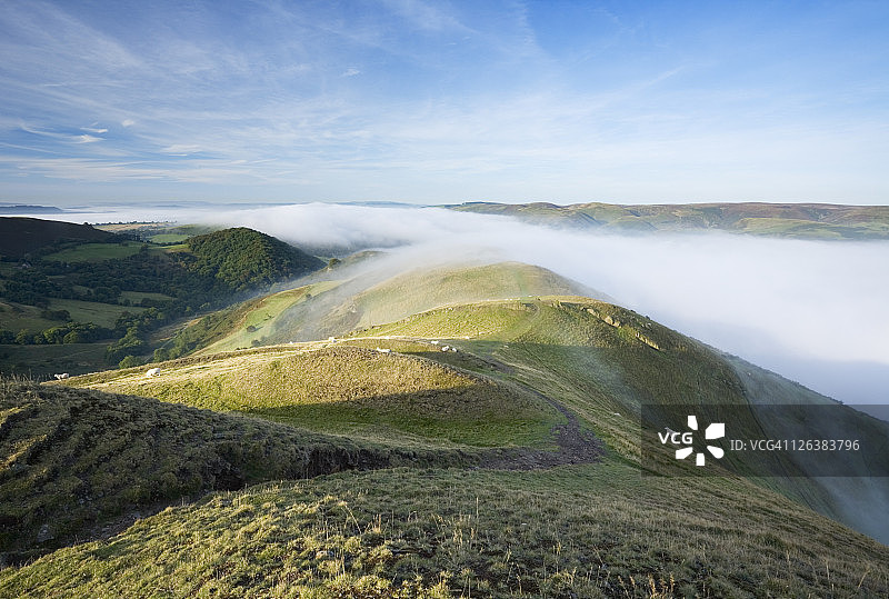 英格兰什罗普郡卡尔卡拉多克山上俯瞰教堂斯特雷顿和远处Long Mynd的薄雾图片素材