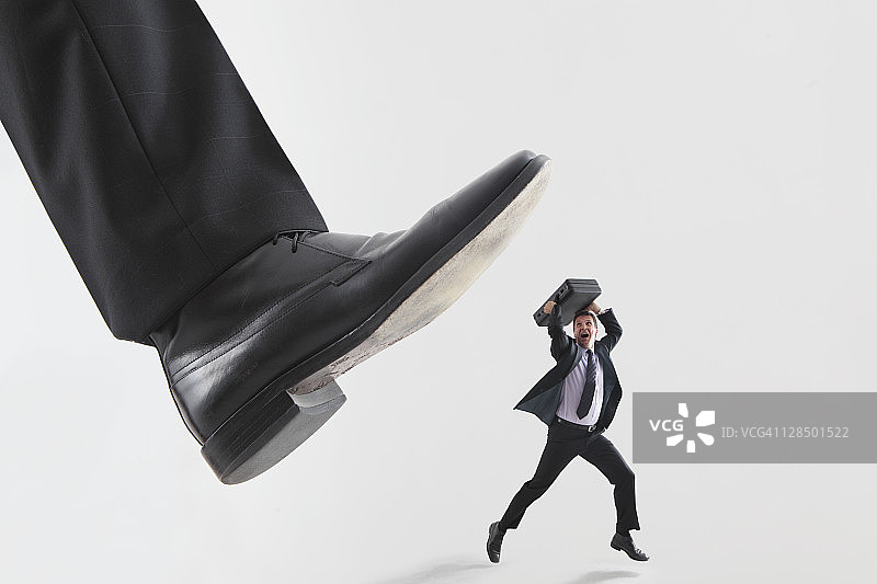 巨脚踩踏男性高管图片素材