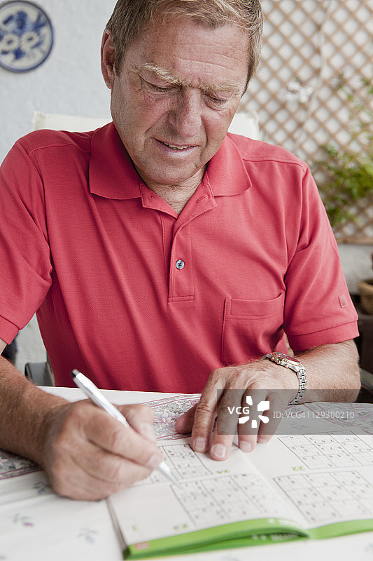 完成数独谜题的老人图片素材