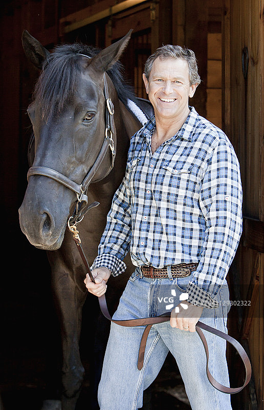 白人男人手持马缰绳图片素材