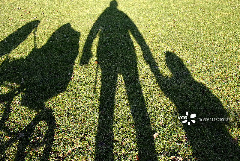 男人和孩子在草地上散步图片素材