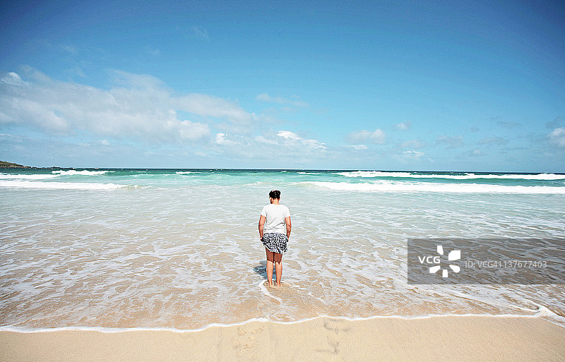 在清澈的蓝色海水中划船的女孩图片素材