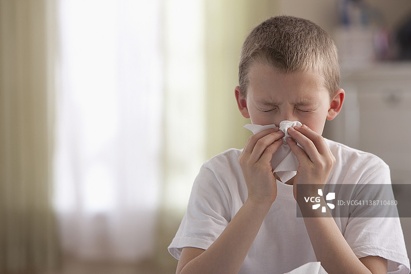 擤鼻子的白人男孩图片素材