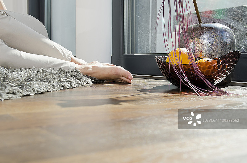 女人躺在装饰碗旁边的地毯上图片素材