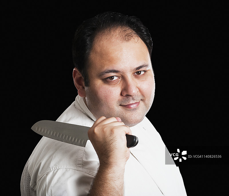 厨师拿着刀的肖像图片素材
