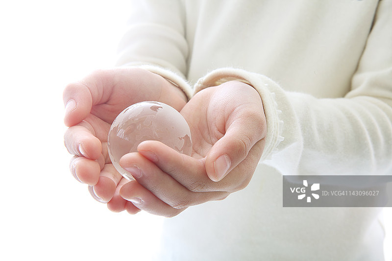 女孩手中的透明地球仪特写图片素材