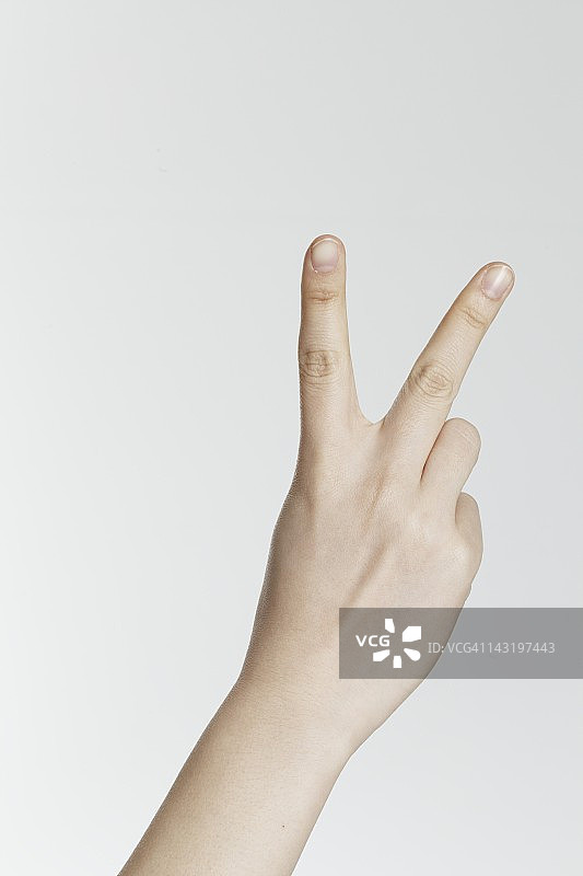 妇女做出和平手势，手部特写图片素材