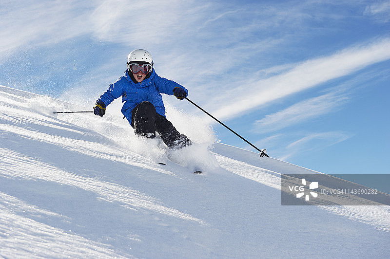 男孩在雪山坡上滑雪图片素材