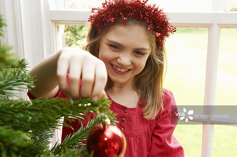 女孩装饰圣诞树图片素材