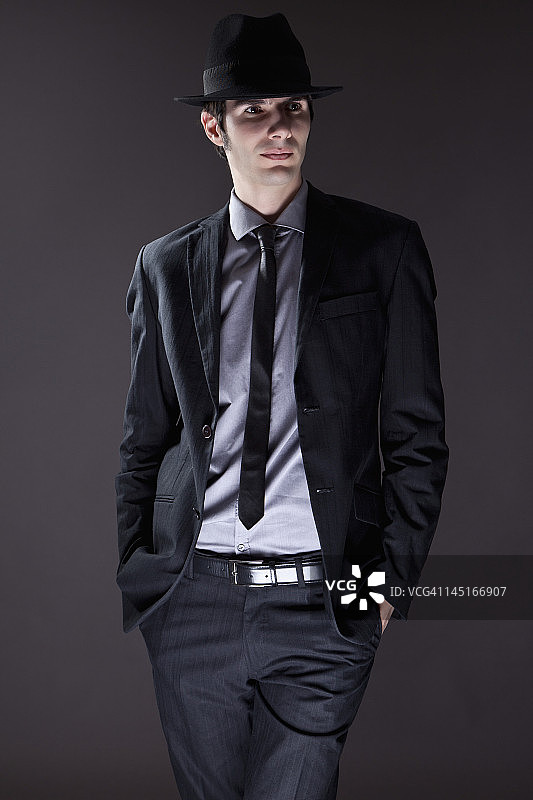 戴帽子的黑色西装青年图片素材
