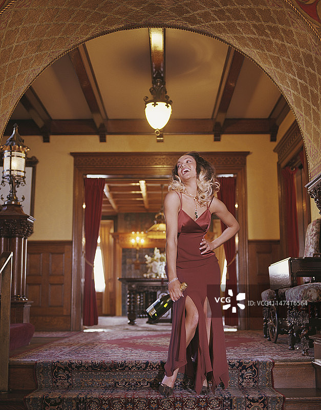 穿着晚礼服拿着瓶子的女人图片素材