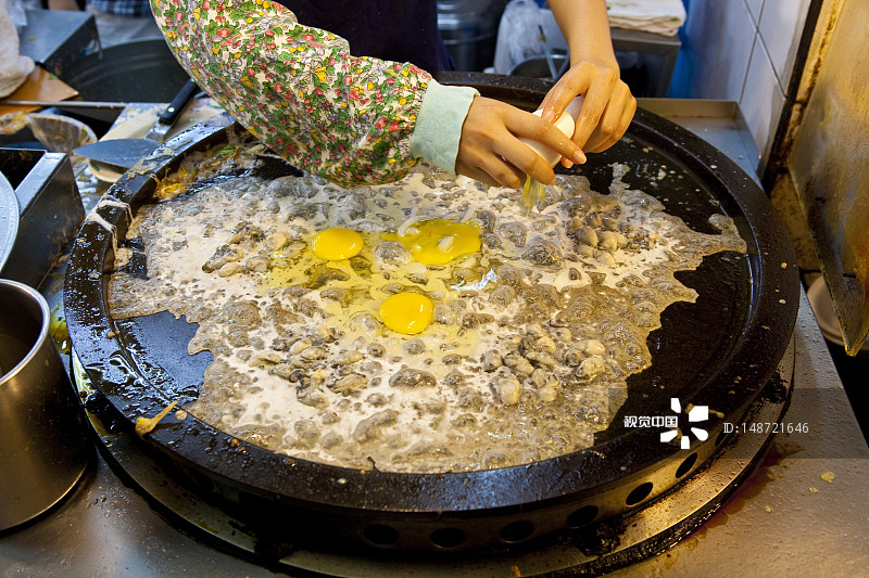 女人在士林夜市的摊位上准备食物图片素材