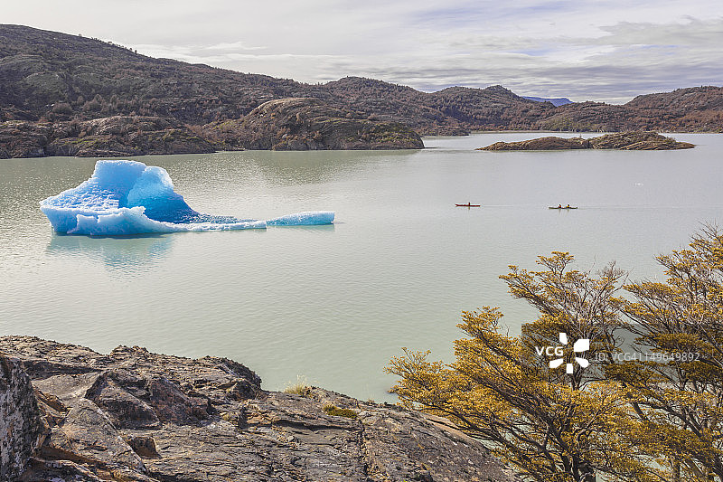 皮划艇和灰色湖上的冰山图片素材