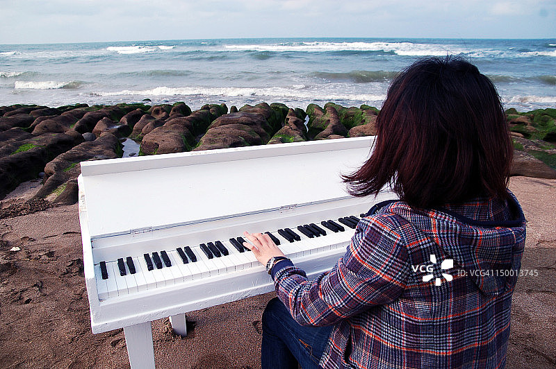 女人弹奏玩具钢琴图片素材