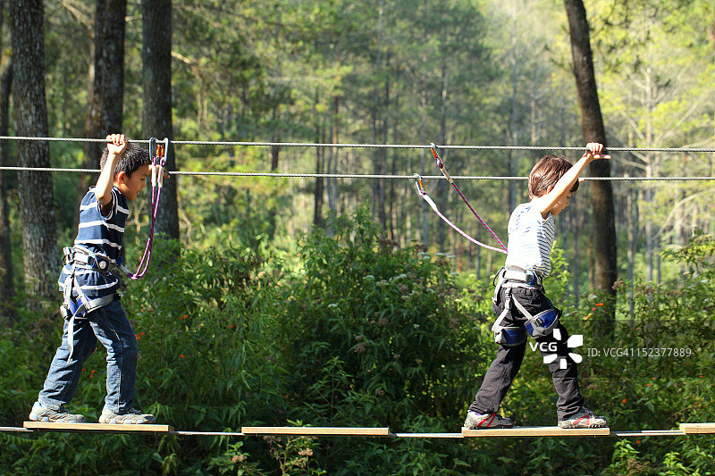 在绳索上行走的男孩们图片素材